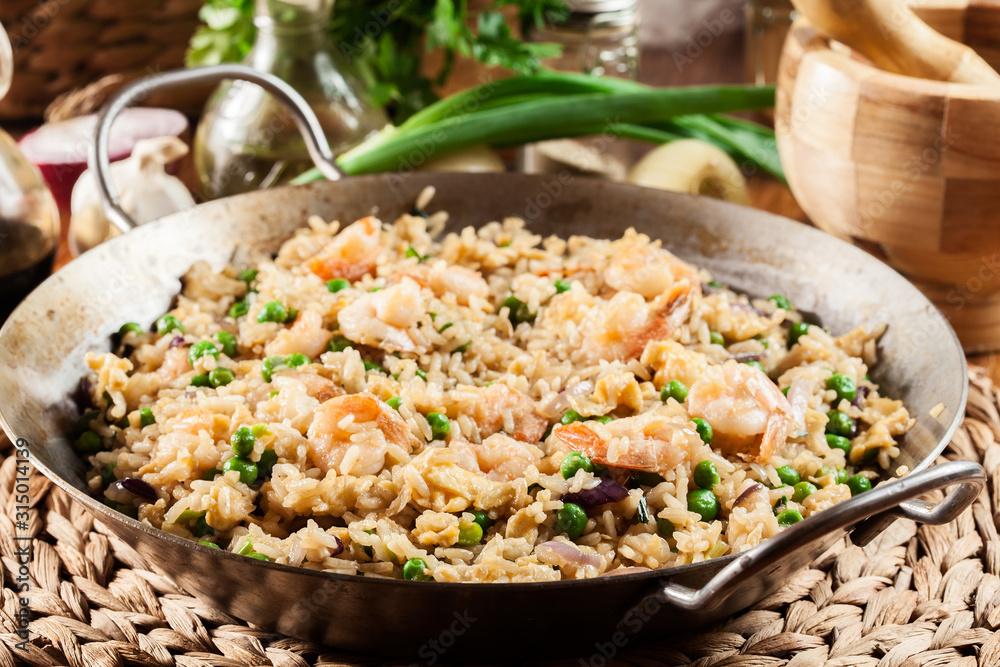 Fried rice with shrimp and vegetables on a frying pan Fried rice with shrimp and vegetables on a frying pan