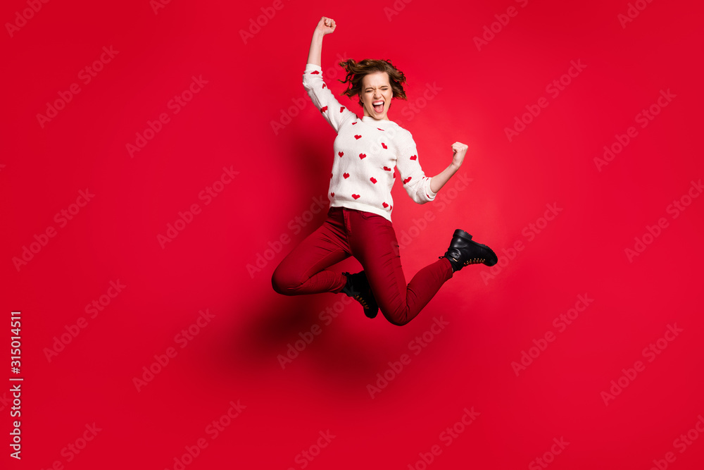 Full length body size view of nice attractive lovely overjoyed crazy cheerful cheery glad girl jumping having fun rejoicing isolated on bright vivid shine vibrant red color background