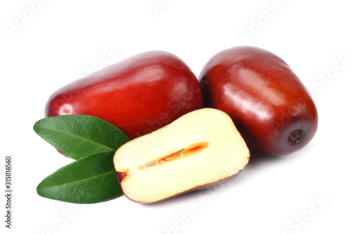 fresh date fruit with sleces and leaves isolated on white background