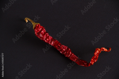 dried chili peppers on a dark background