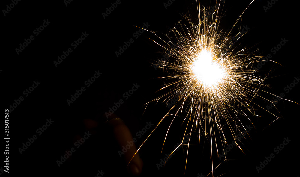 bright festive new year Sparkler on a black background with a copy of the space