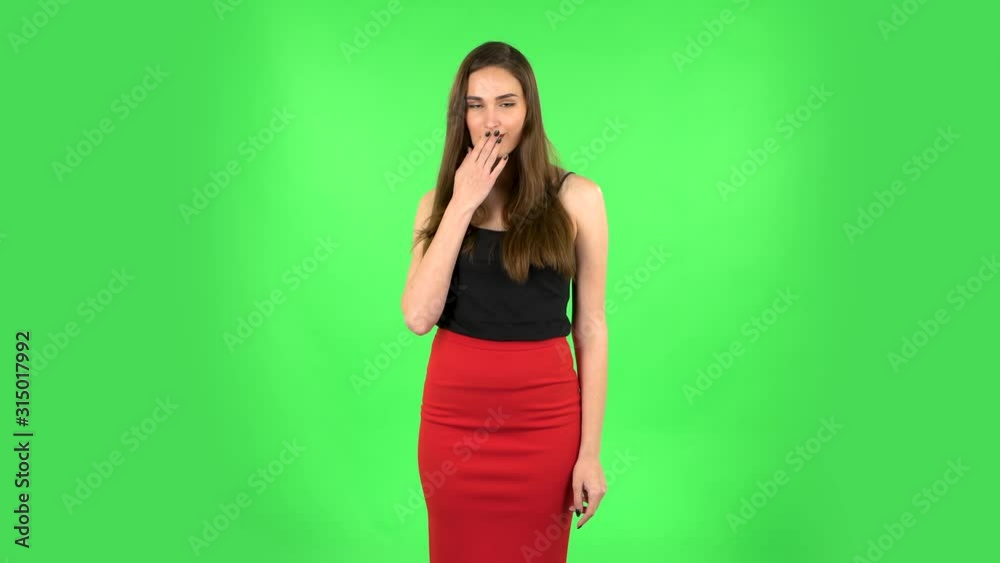 Cute girl smiles and showing heart with fingers then blowing kiss. Green screen