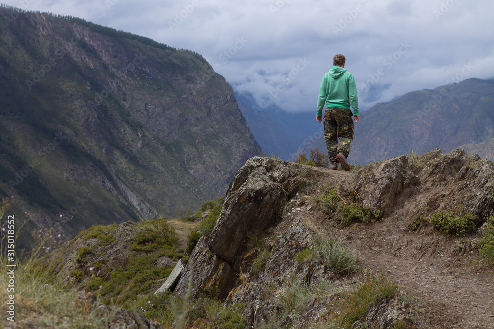hiker on the top of mountain on the pass katu yaryk in altai hiker on the top of mountain on the pass katu yaryk in altai