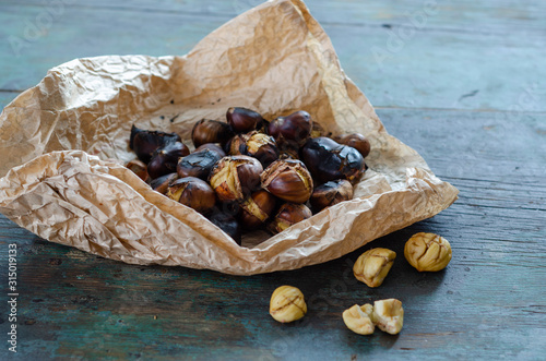Grilled chestnuts on the wooden table.