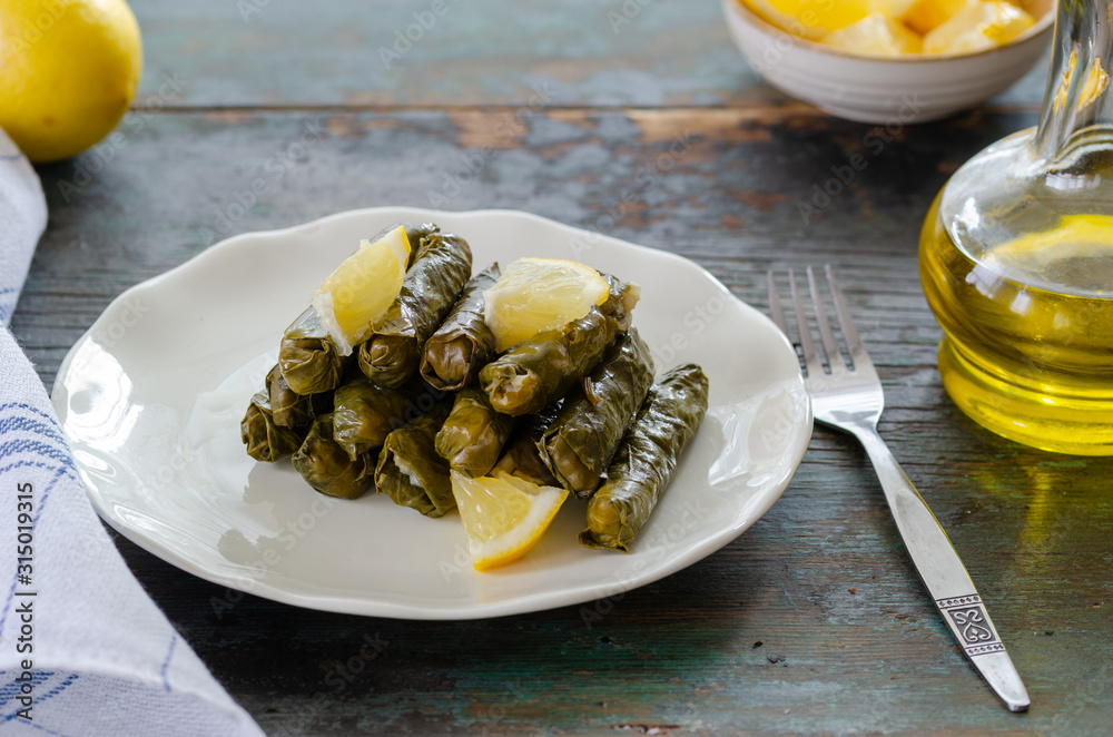 Stuffed grape leaves with rice,olive oil and herbs in white plate