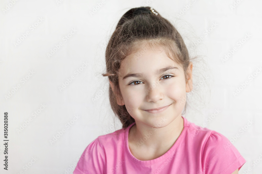 Portrait of happy laughing child girl on light background. Smiling kid. Positive emotions. Portrait of happy laughing child girl on light background. Smiling kid. Positive emotions.