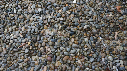 River rocks of many colors, large and small textured background
