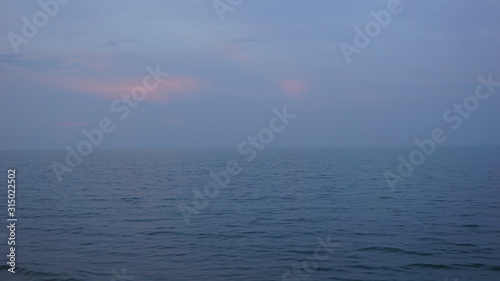 Sea view, sunlight, soft orange light hits the clouds. Beautiful sky