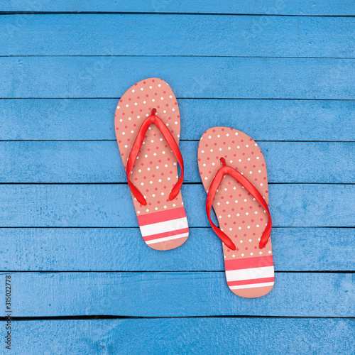 flip flops on wooden blue table