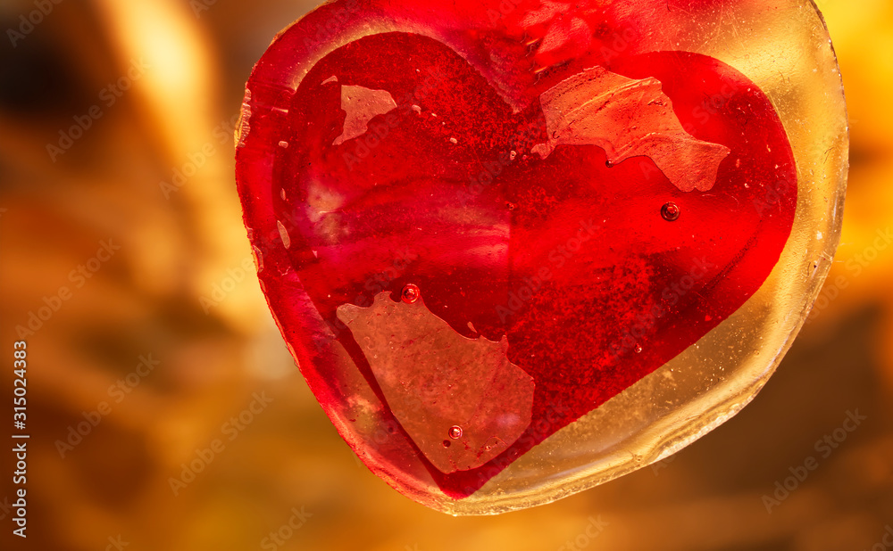 Red Valentines heart in amber. Macro image. Happy Valentines Day
