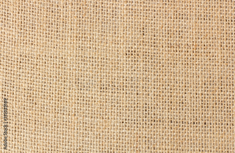 Burlap texture background / Cotton woven fabric backdrop with flecks of varying colors of beige and brown. with copy space. office desk or Dining table concept. canvas bag empty space for text. Burlap texture background / Cotton woven fabric backdrop with flecks of varying colors of beige and brown. with copy space. office desk or Dining table concept. canvas bag empty space for text.