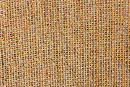 Burlap texture background / Cotton woven fabric backdrop with flecks of varying colors of beige and brown. with copy space. office desk or Dining table concept. canvas bag empty space for text.