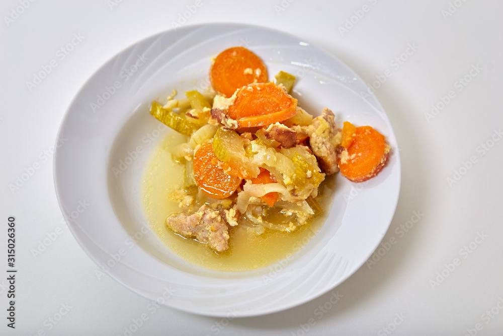 preparation of home dishes of meat with zucchini, carrots, onions and spices, close-up preparation of home dishes of meat with zucchini, carrots, onions and spices, close-up