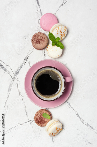 French macaroons with different flavors and cup of coffee