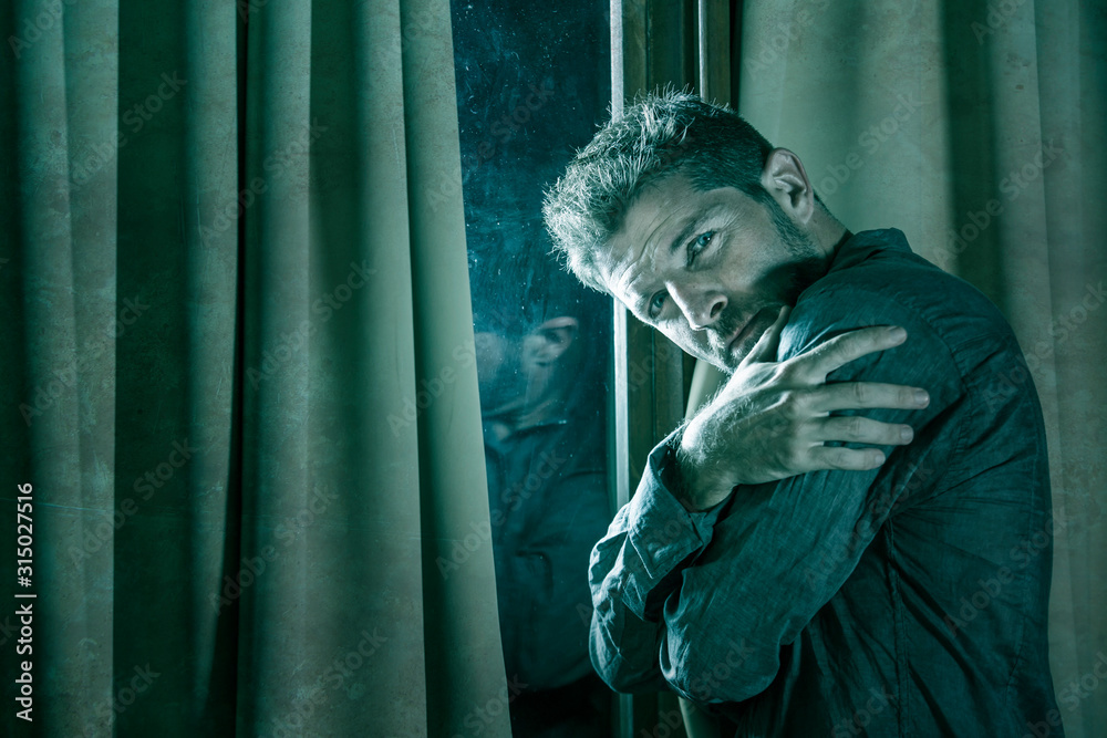 Obraz premium dramatic portrait of depressed and sick man suffering from psychosis illness or mental disorder looking weird and helpless in psychiatric and psychological problem concept