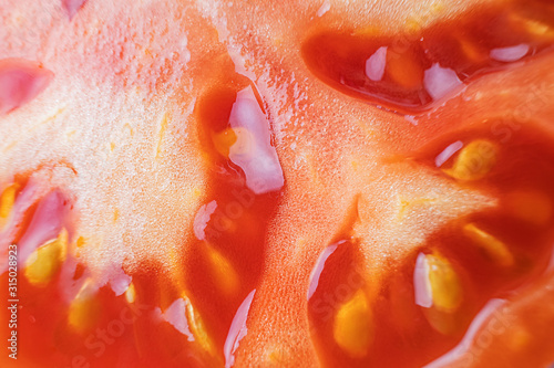 The pulp of a tomato close-up, macro photo. Organic natural food concept. Fresh ripe tomato.