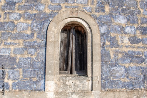 Ancient stone window of an old stone house in a countryside village in Puglia, Italy, Europe © Michele Ursi