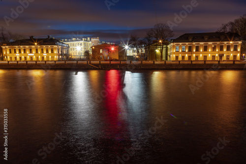 Beautiful dawn in St. Petersburg over the river. Reflection in the water of lanterns. © M.V.schiuma