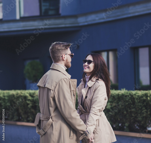 Smiling couple in love outdoor. Street portrait of fashionable couple