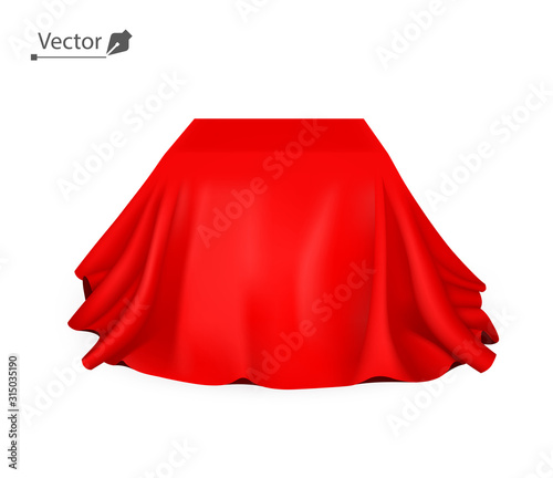 Box covered with red silk cloth. Empty podium, stand with tablecloth to show magic tricks. Secret gift, hidden under satin fabric with drapery and folds.