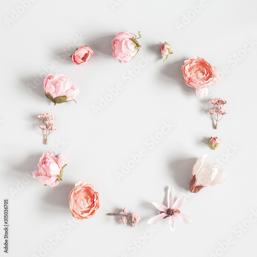 Flowers composition. Wreath made of pink flowers on pastel gray background. Valentines day, mothers day, womens day concept. Flat lay, top view, copy space, square
