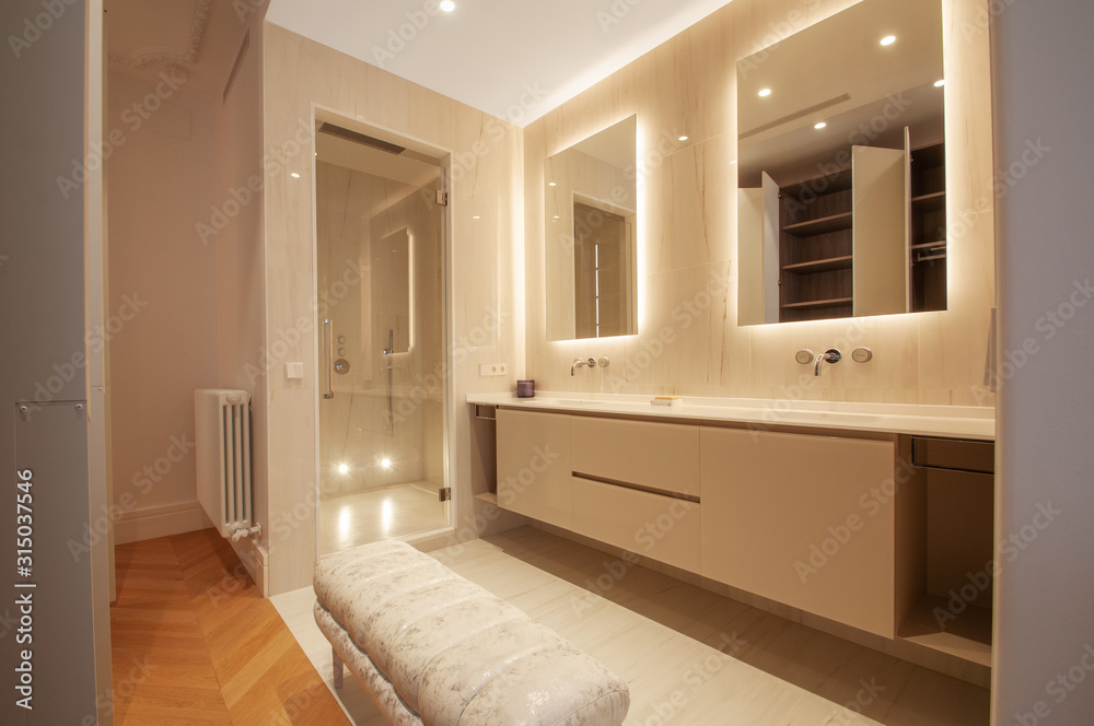 Fototapeta premium Luxurious Modern Bathroom interior design whith double sink, two mirrors and Tuffet.