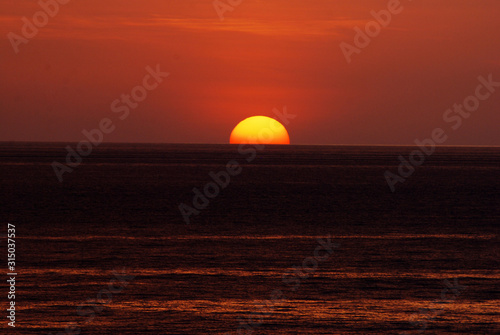 Fototapeta Naklejka Na Ścianę i Meble -  Nature seascape of Tranquil scene red sun and  red sky sunset over the sea at phuket Thailand.- Red orange nature backdrop and background concept