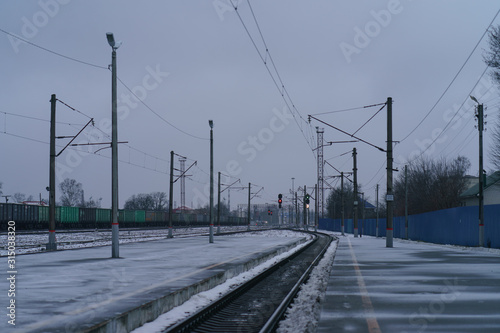 Photography of russian railway station in the winter. Freight train wagons. White snowy frozen landscape. Touristic concepts and calmness.