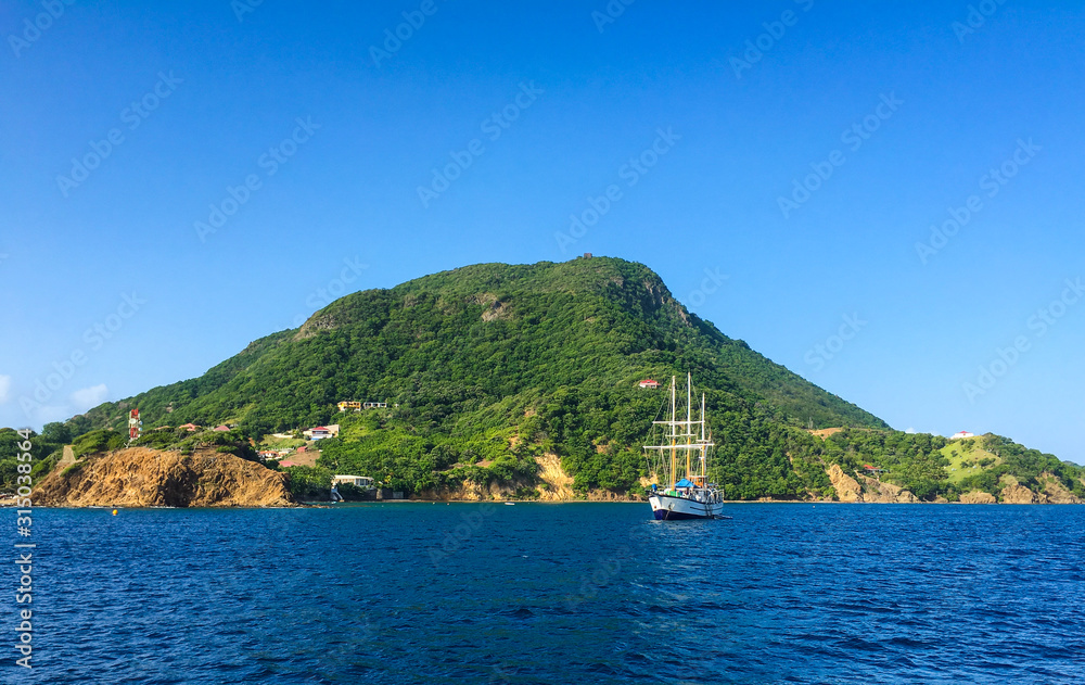 View of a Tropical Island and Sailboat