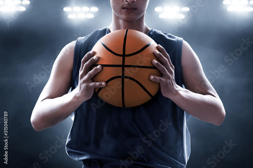 Basketball player holding a ball © fotokitas