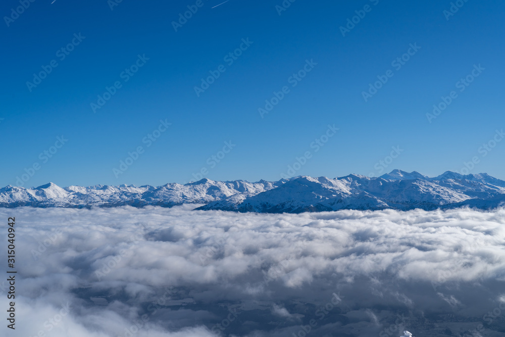 Snowy mountain peaks above clouds