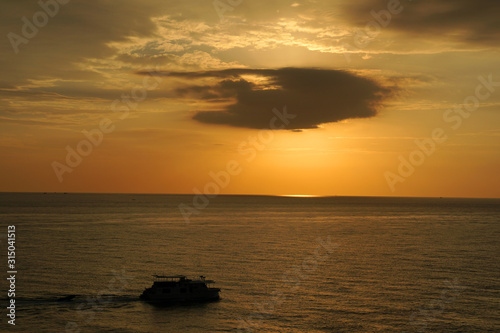 Nature seascape of Tranquil scene Sun behind the dark clouds and twilight sky sunset  over the sea at phuket Thailand. - Travel nature backdrops                                © kittinit