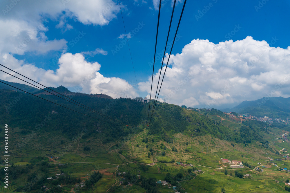 Cable car riding over mountain landscape. Travel adventures background