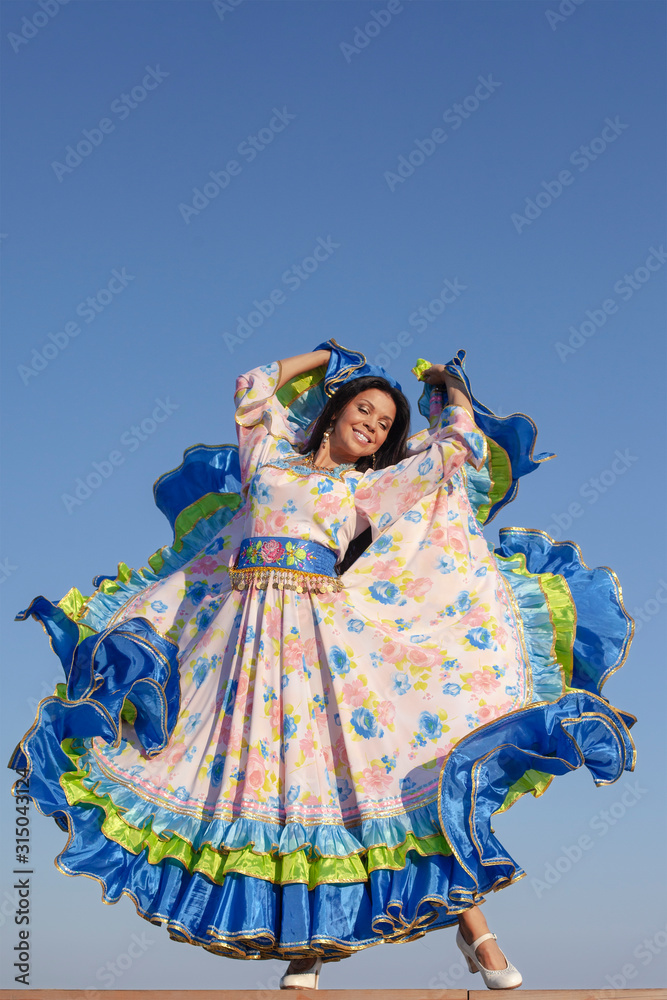 young woman dancing in gypsy dress