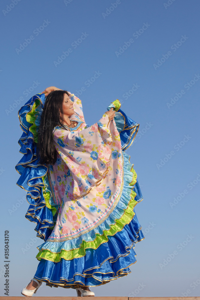 Fototapeta premium young woman dancing in gypsy dress