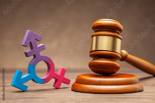 Konstfotografi Transgender symbol and judge gavel on brown background
