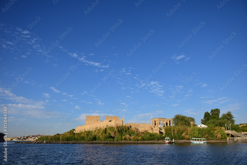 Fototapeta premium Ancient pharaohs Philae temple in Aswan Egypt in the river nile , old temple have hieroglyphs craved in its stones/Trajan's Kiosk / obelisk , Ancient Egypt Monuments 