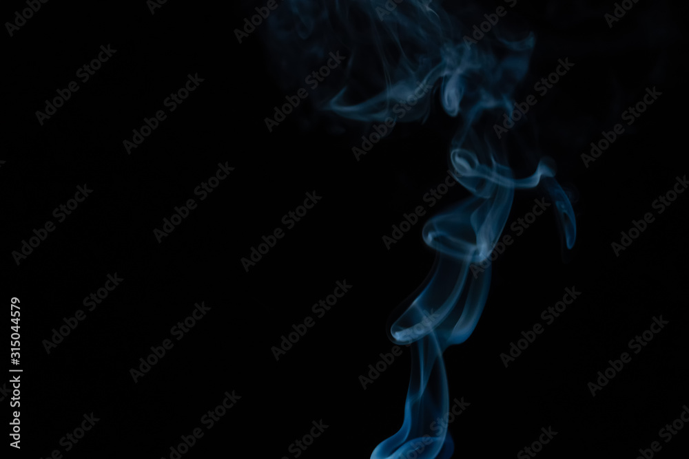 Beautiful abstract blue smoke with copy space on black background. Smoke background for art design or drawing. Abstract figure of the smoke Beautiful abstract blue smoke with copy space on black background. Smoke background for art design or drawing. Abstract figure of the smoke