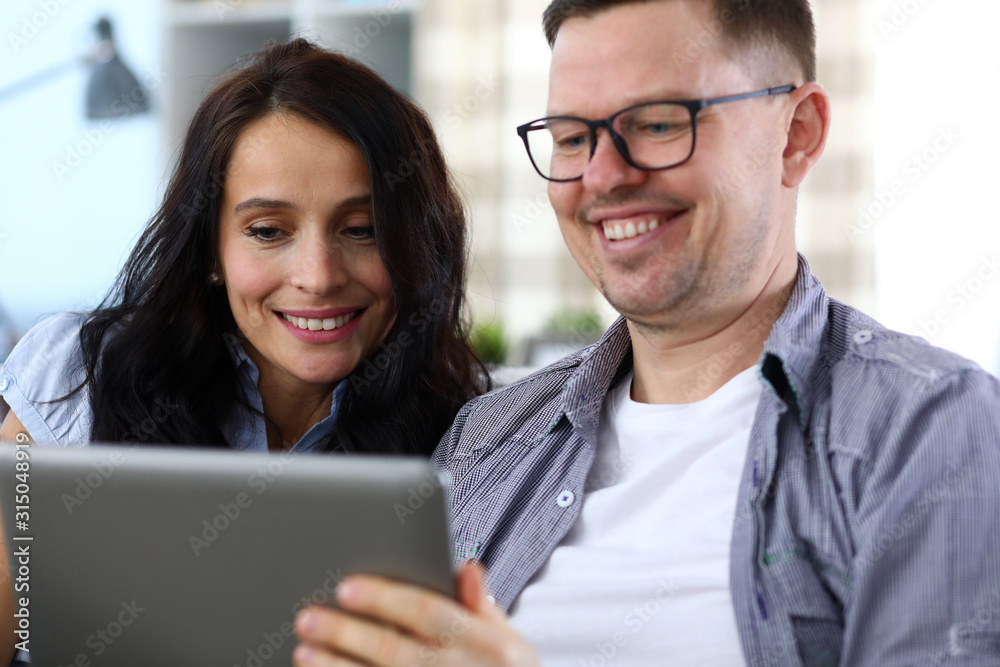 Happy couple looking at tablet Happy couple looking at tablet
