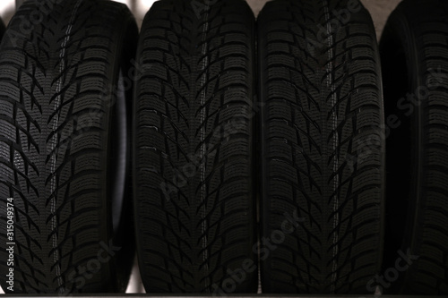 Car tires in auto store, closeup view