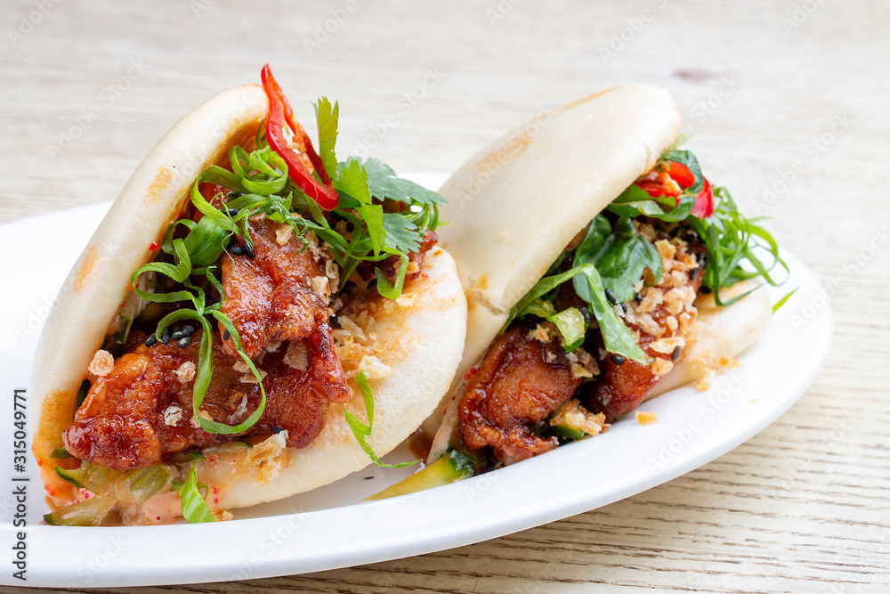 Bao..Rice steamed buns with chicken, spicy herbs and chili peppers. Pan-Asian dish. Bao..Rice steamed buns with chicken, spicy herbs and chili peppers. Pan-Asian dish.