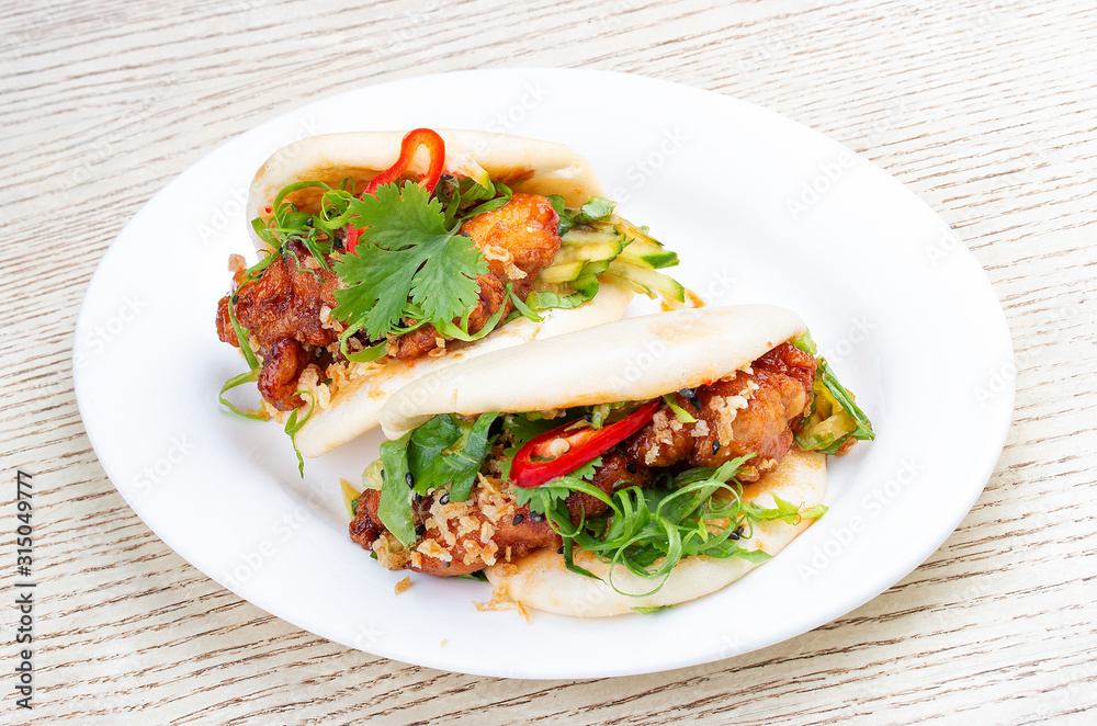 Bao..Rice steamed buns with chicken, spicy herbs and chili peppers. Pan-Asian dish. Bao..Rice steamed buns with chicken, spicy herbs and chili peppers. Pan-Asian dish.