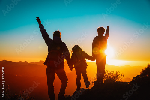 father with kids travel in sunset mountains, happy family in nature