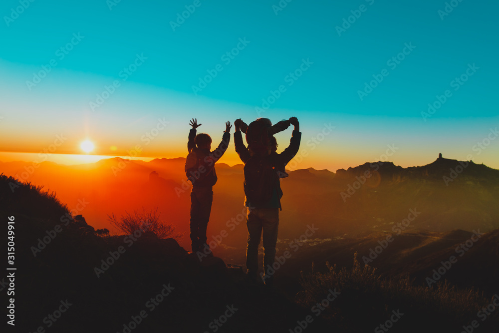 Fototapeta premium father with kids travel in sunset mountains, happy family in nature
