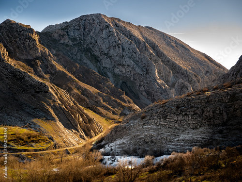 mountainous landscape with icy fields at dawn photo