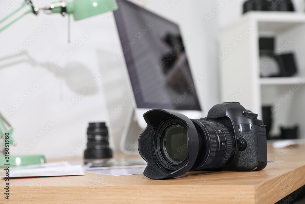 Photographer's workplace with professional camera in office - obrazy, fototapety, plakaty 