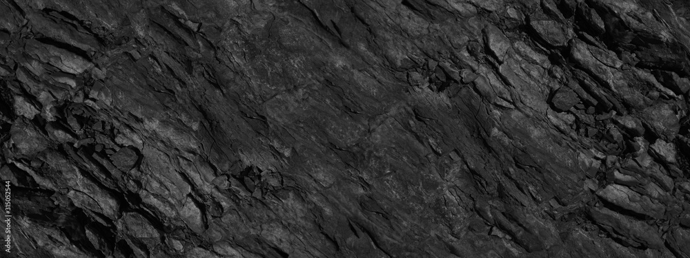 Black grunge background. Abstract stone background. Beautiful mountain texture pattern. Stone grunge banner. Dark gray rock backdrop.