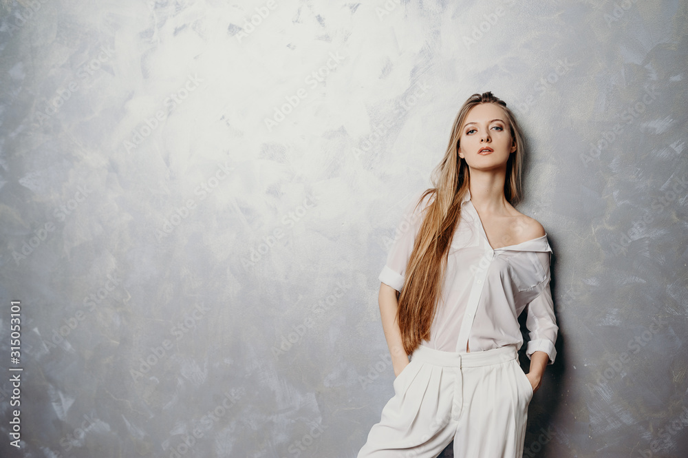 Portrait of cheerful lady. Background gray wall.