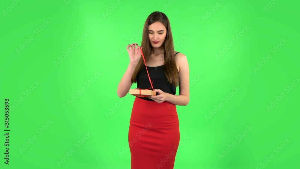 Girl opens the gift, very surprised and rejoices. Green screen Girl opens the gift, very surprised and rejoices. Green screen