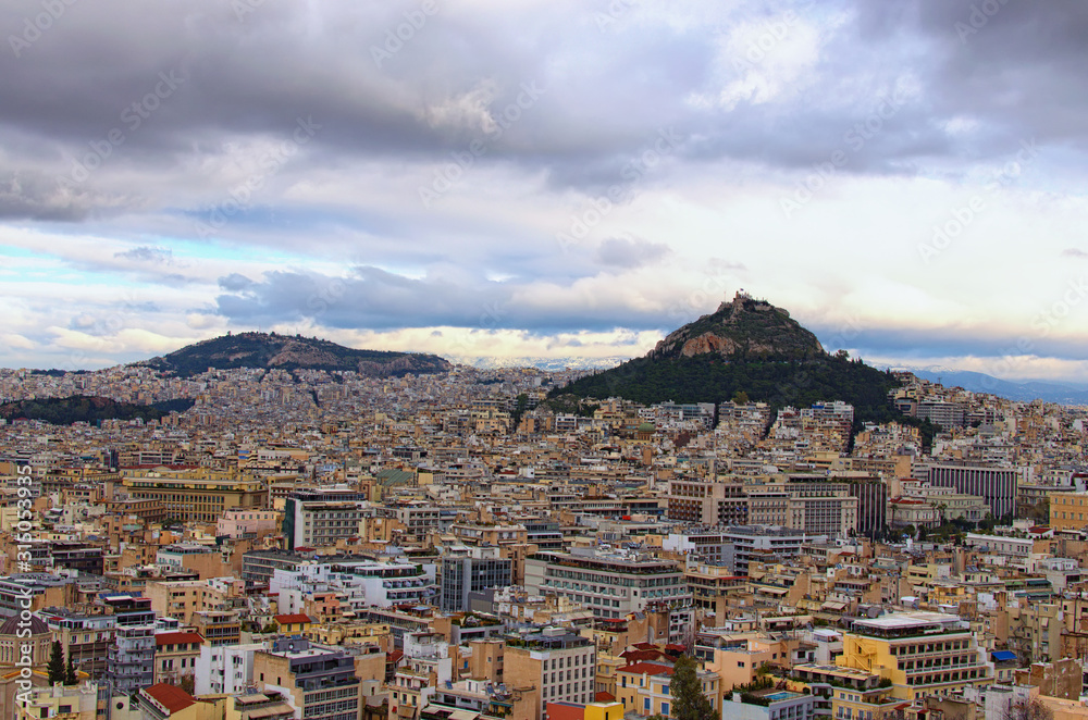 Scenic aerial view over the city of Athens against cloudy sky. Famous touristic place and travel destination in Europe. Greece